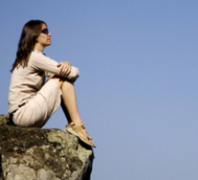 Woman meditating on rock